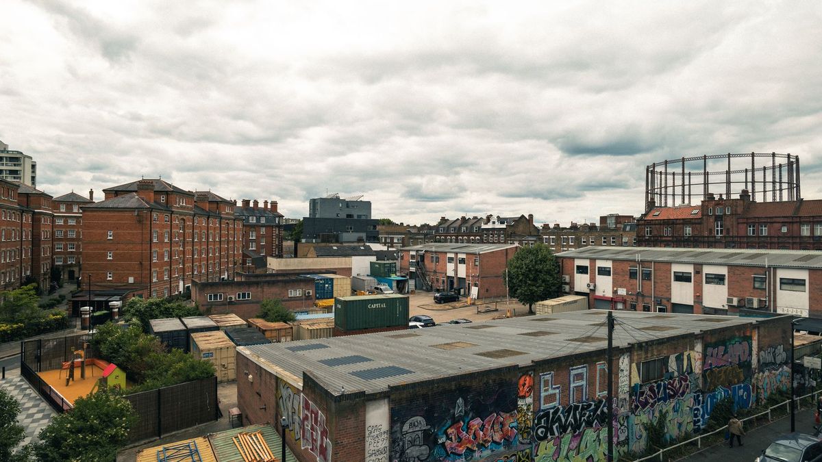 Rooftops, brick buildings and a gasholder in East London