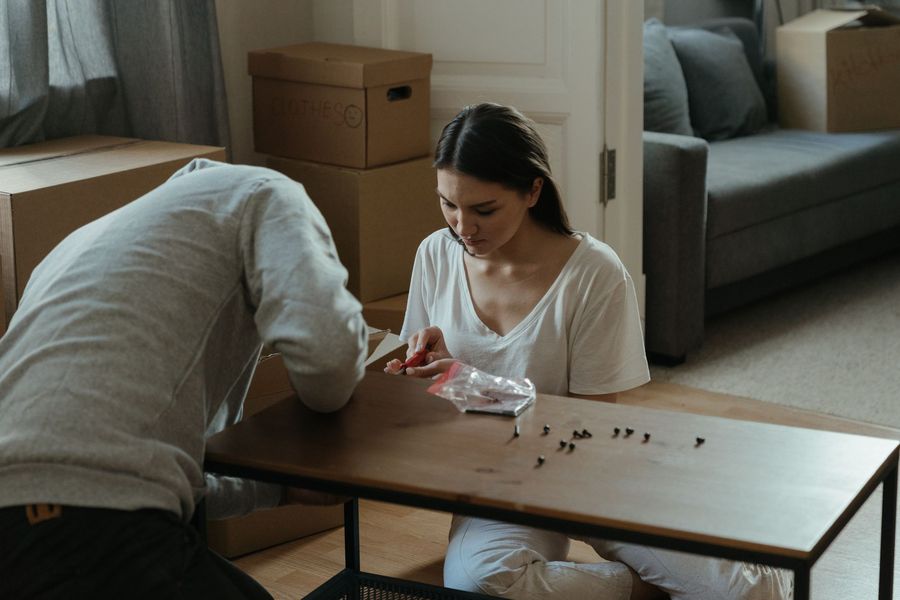 Flat-pack furniture being assembled with hand tools